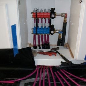 hydronic floor heating manifold in cupboard