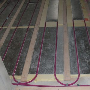 close up of hydronic pipe between timer battens on diffusion plates