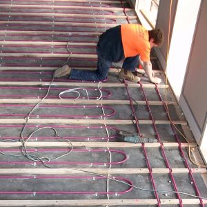 installing hydronic pipe between timber battens